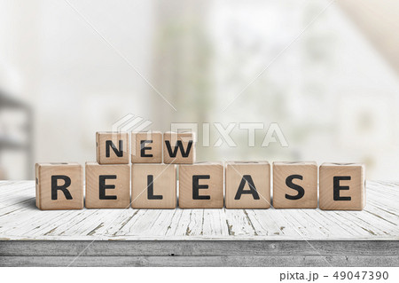 New release sign on a wooden table in a bright New release sign on a wooden table in a bright 49047390