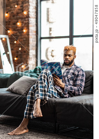 Nice good looking man sitting with crossed legs 49047858