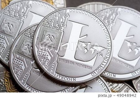 Group of silver litecoin coins, close-up. 49048942