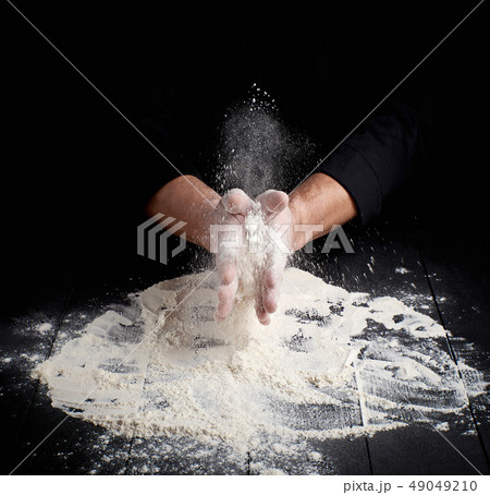 man's hands and splash of white wheat flour man's hands and splash of white wheat flour 49049210