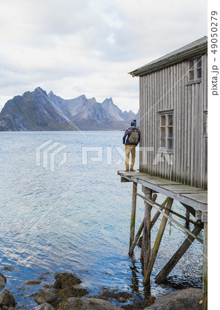 Traveler on a wooden pier 49050279