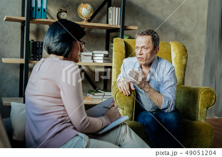 Expressive unpleasant man leaning on sofa and actively gesturing Expressive unpleasant man leaning on sofa and actively gesturing 49051204