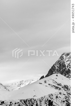 Snowy mountain pass and cloudy gray sky at winter Snowy mountain pass and cloudy gray sky at winter 49051743
