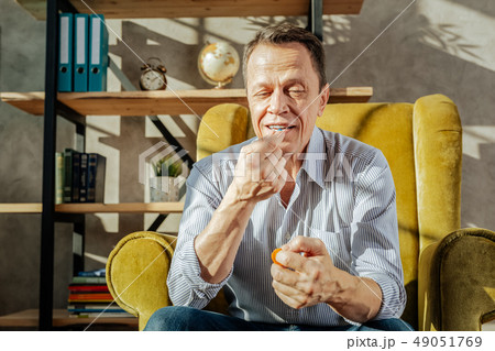 Positive short-haired man in light shirt and blue jeans Positive short-haired man in light shirt and blue jeans 49051769