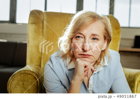 Adult short-haired woman with blue eyes being unhappy and depressed Adult short-haired woman with blue eyes being unhappy and depressed 49051867