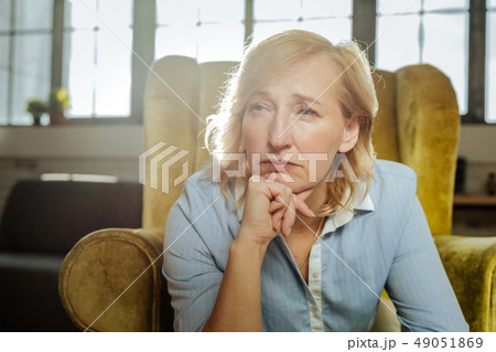 Tired and upset blonde woman propping her chin 49051869