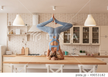 Flexible and strong young yoga master showing her outstanding skills 49053182