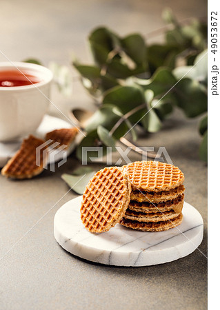 Syrupwaffles cookies and cup of tea Syrupwaffles cookies and cup of tea 49053672