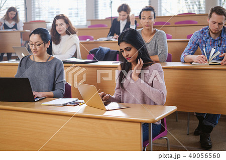 Multinational group of students in an auditorium 49056560