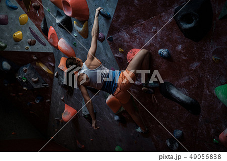 Athletic woman practicing in a bouldering gym 49056838
