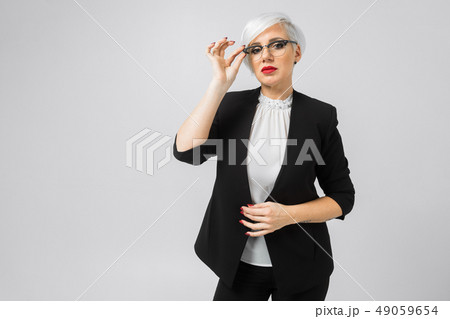 Portrait of young buisness lady in costumes isolated on background 49059654
