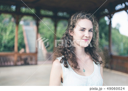 Beautiful curly hair girl in a light blue dress Beautiful curly hair girl in a light blue dress 49060024