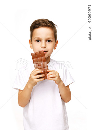 little beautiful boy holding chocolate studio shot  49060971