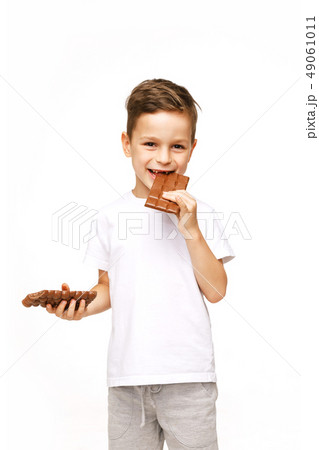 little beautiful boy holding chocolates studio shot little beautiful boy holding chocolates studio shot 49061011