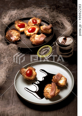 Few puff pastry cups filled by cheese and ham on Few puff pastry cups filled by cheese and ham on 49062283