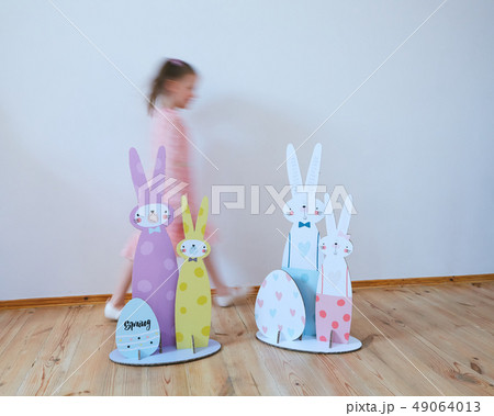 Cardboard Easter bunnies. Easter decor for party. Film effect 49064013