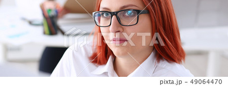 Beautiful smiling cheerful girl at workplace look 49064470