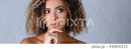 Beautiful black woman portrait. Looks upwards to the right Beautiful black woman portrait. Looks upwards to the right 49064915