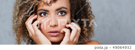 A beautiful black woman portrait. Tests the emotion of bewilderment A beautiful black woman portrait. Tests the emotion of bewilderment 49064932