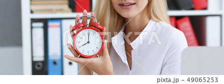 Smiling business woman holding in hand clock 49065253