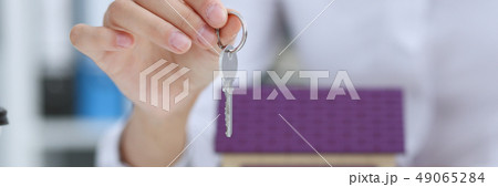Female hand holds the key to the lock in the hand Female hand holds the key to the lock in the hand 49065284