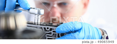 Repairman of a car-care center on repair of automatic transmissi 49065949