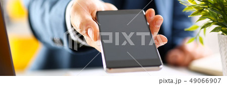Male arm in suit show in camera phone display 49066907