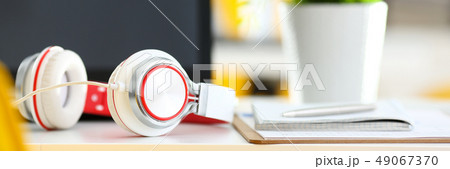 Empty remote office workplace with laptop and headset 49067370