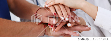 Group of doctor crossed arms in pile for win 49067564