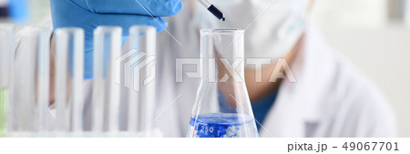 A male chemist holds test tube of glass A male chemist holds test tube of glass 49067701