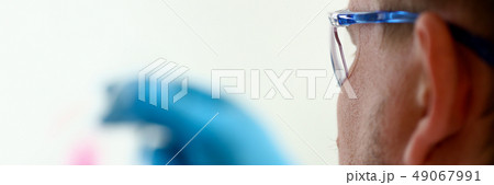 A male chemist holds test tube of glass A male chemist holds test tube of glass 49067991