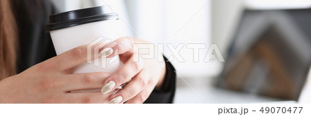 A woman in a workplace in the office holds 49070477