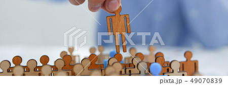 businessman in blue shirt is holding a magnifying glass in his h 49070839