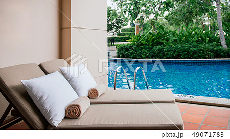 Resort pool beds at outdoor balcony by swimming 49071783