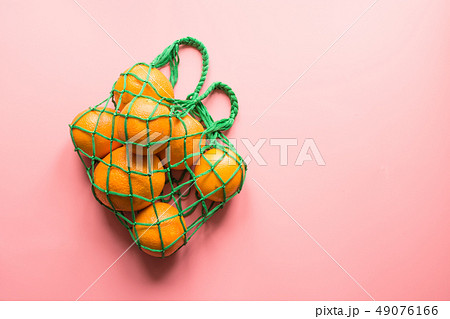 Shopping bag with orange on pink. Zero waste. Shopping bag with orange on pink. Zero waste. 49076166