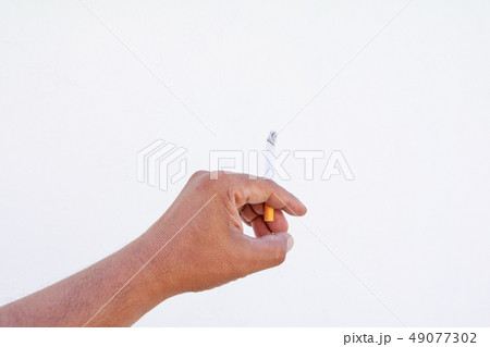 hand holding burn cigarette at hazard isolated  49077302