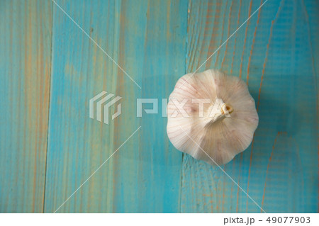 Garlic bulb on the wooden vintage background Garlic bulb on the wooden vintage background 49077903
