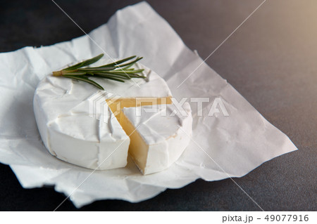Cheese camembert or brie with fresh rosemary Cheese camembert or brie with fresh rosemary 49077916