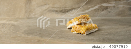 Muesli and cereal bar on marble stone background 49077919