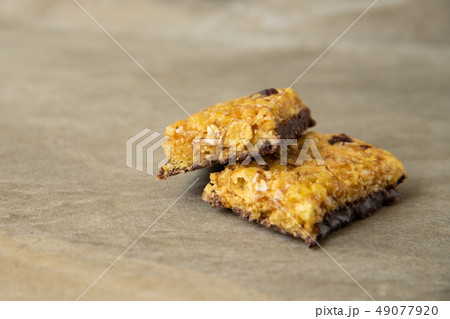 Muesli and cereal bar on marble stone background 49077920