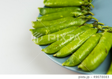 Fresh Green peas closeup on white background Fresh Green peas closeup on white background 49078083