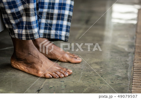 Feet of a nice African American man touching the floor Feet of a nice African American man touching the floor 49079507