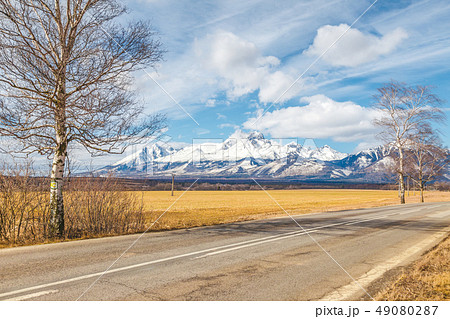 Road through the landscape with snowy mountains. Road through the landscape with snowy mountains. 49080287