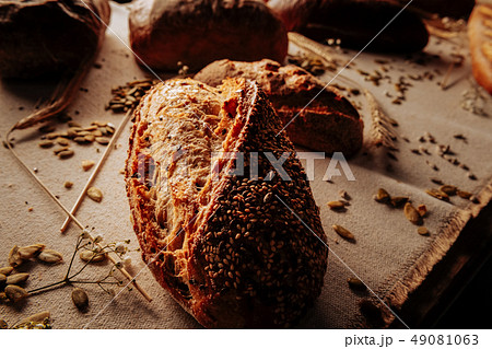 Close up of delicious rye bread topped with seeds lying on table Close up of delicious rye bread topped with seeds lying on table 49081063