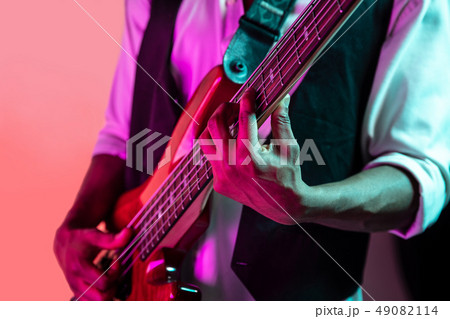 African American jazz musician playing bass guitar. 49082114