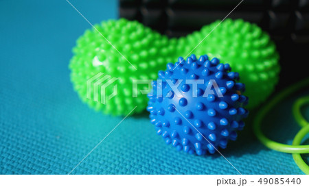Massage ball roller for self massage, reflexology and myofascial release on blue Massage ball roller for self massage, reflexology and myofascial release on blue 49085440