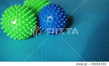 Massage ball roller for self massage, reflexology and myofascial release on blue Massage ball roller for self massage, reflexology and myofascial release on blue 49085450