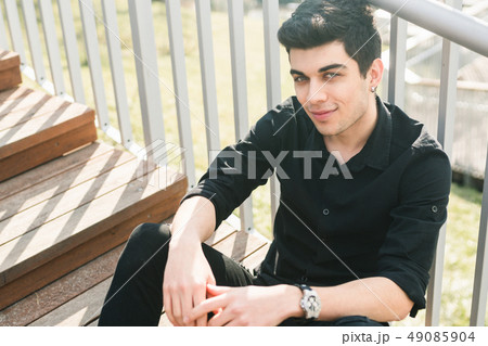 Portrait of a handsome young successful male brunette of a Turkish Mediterranean race sitting on the 49085904