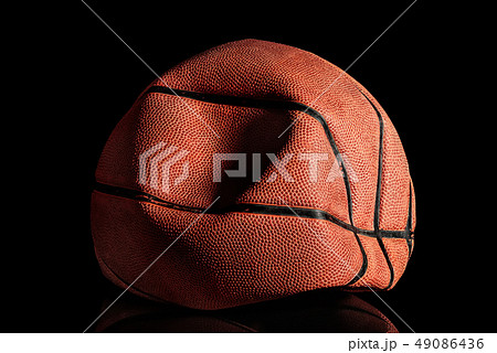 Deflated and rumpled old basketball ball Deflated and rumpled old basketball ball 49086436