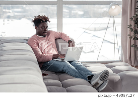 Handsome young freelancer having fluffy brunette hairstyle 49087127